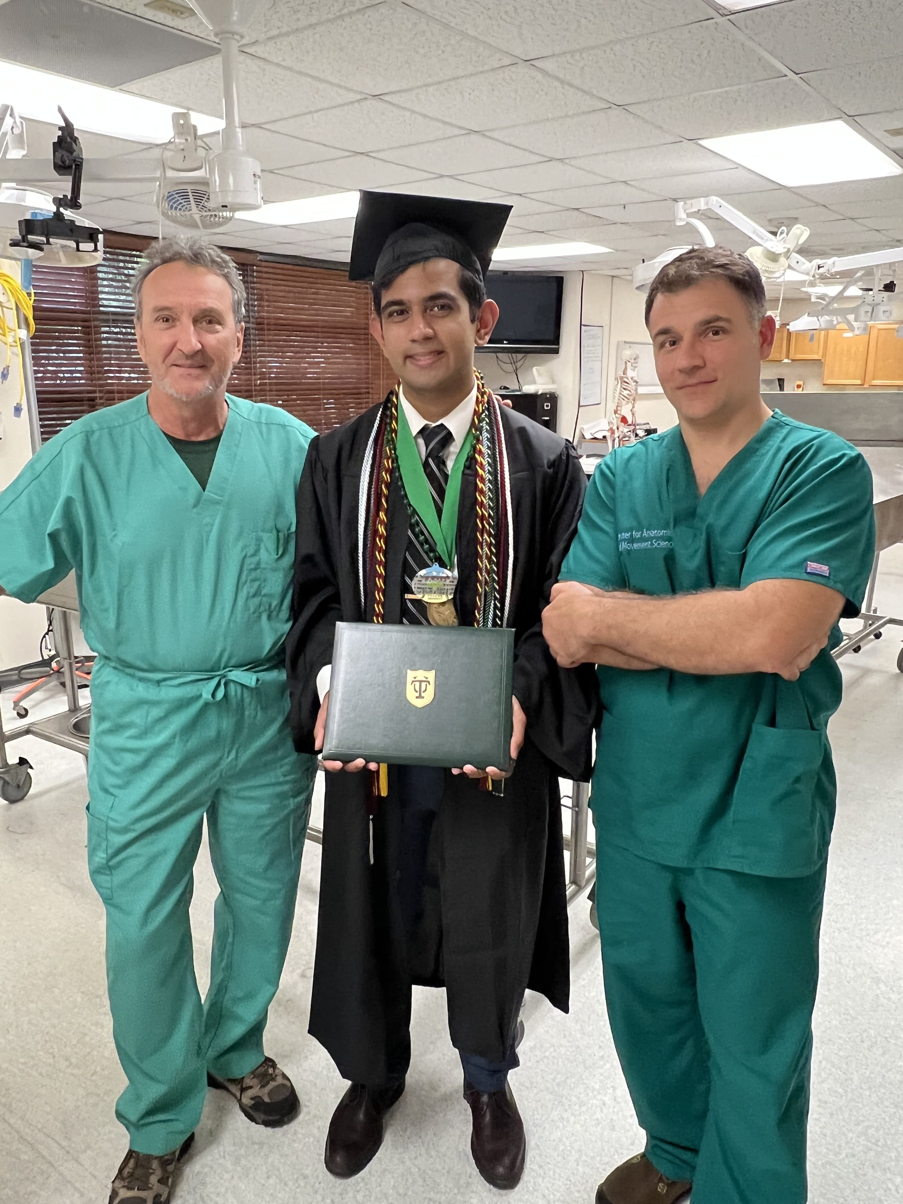 Instructors Michael Dancisak and Dimitri Papadopoulos with CAMS peer learner and 2023 Tulane graduate Ajay Raman.