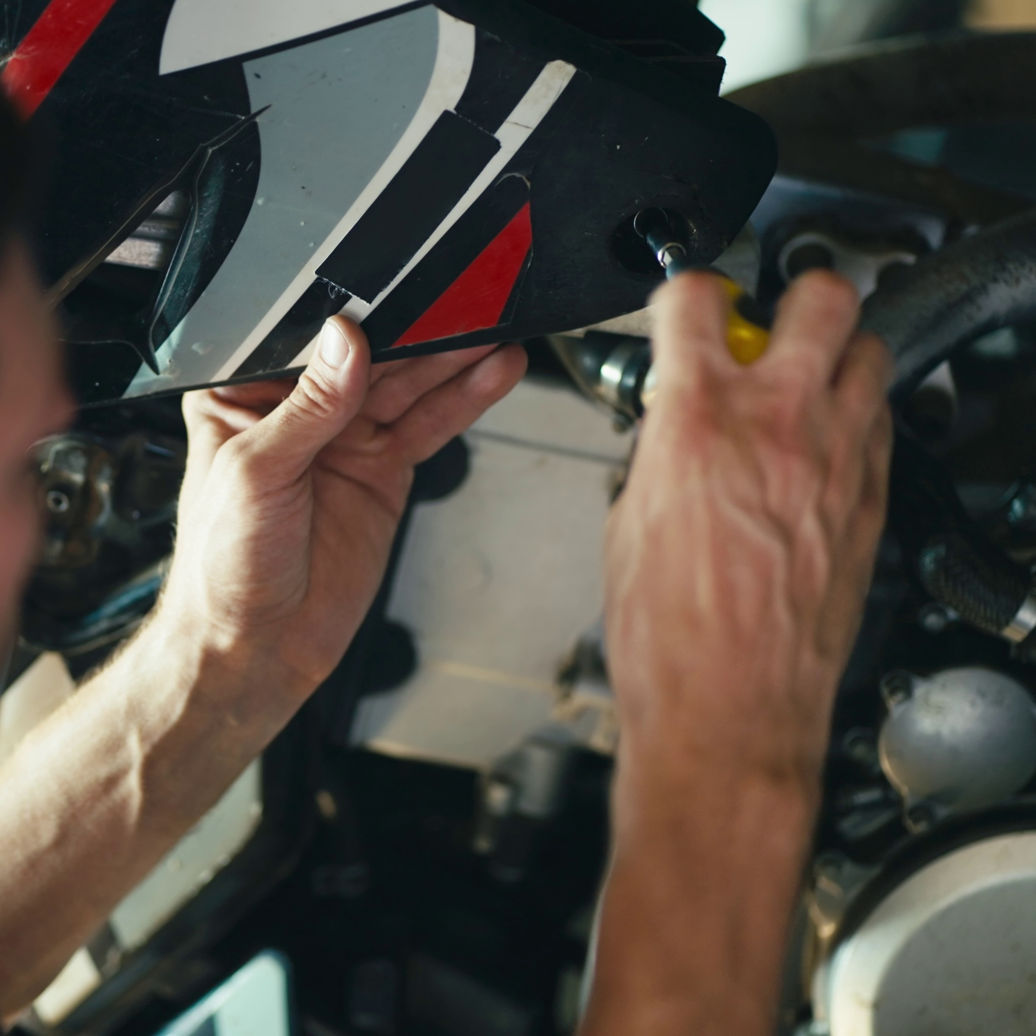 mechanic-unscrews-a-bolt-that-holds-an-external-part