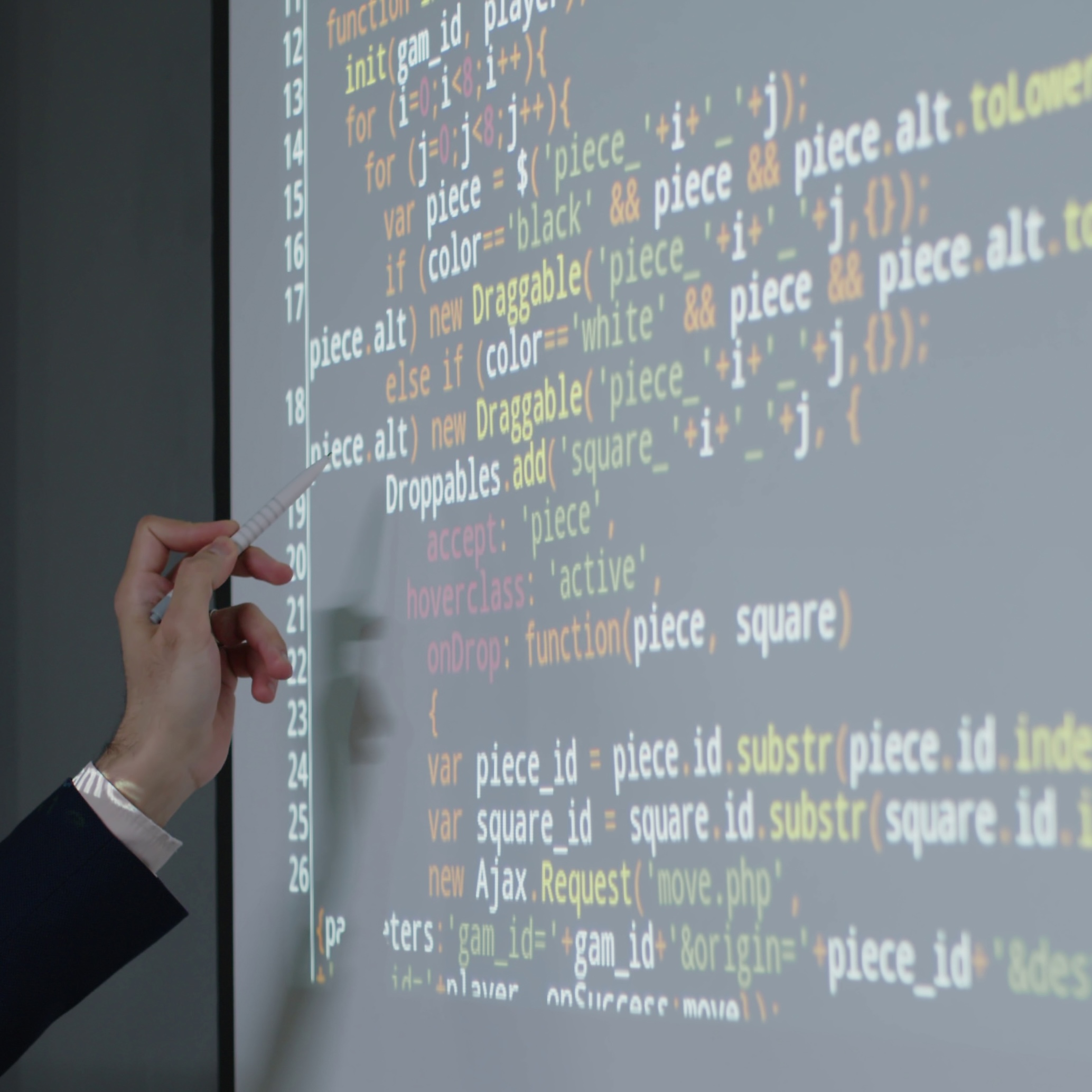 close-up-shot-of-male-computer-science-teacher-pointing-to-projector-screen