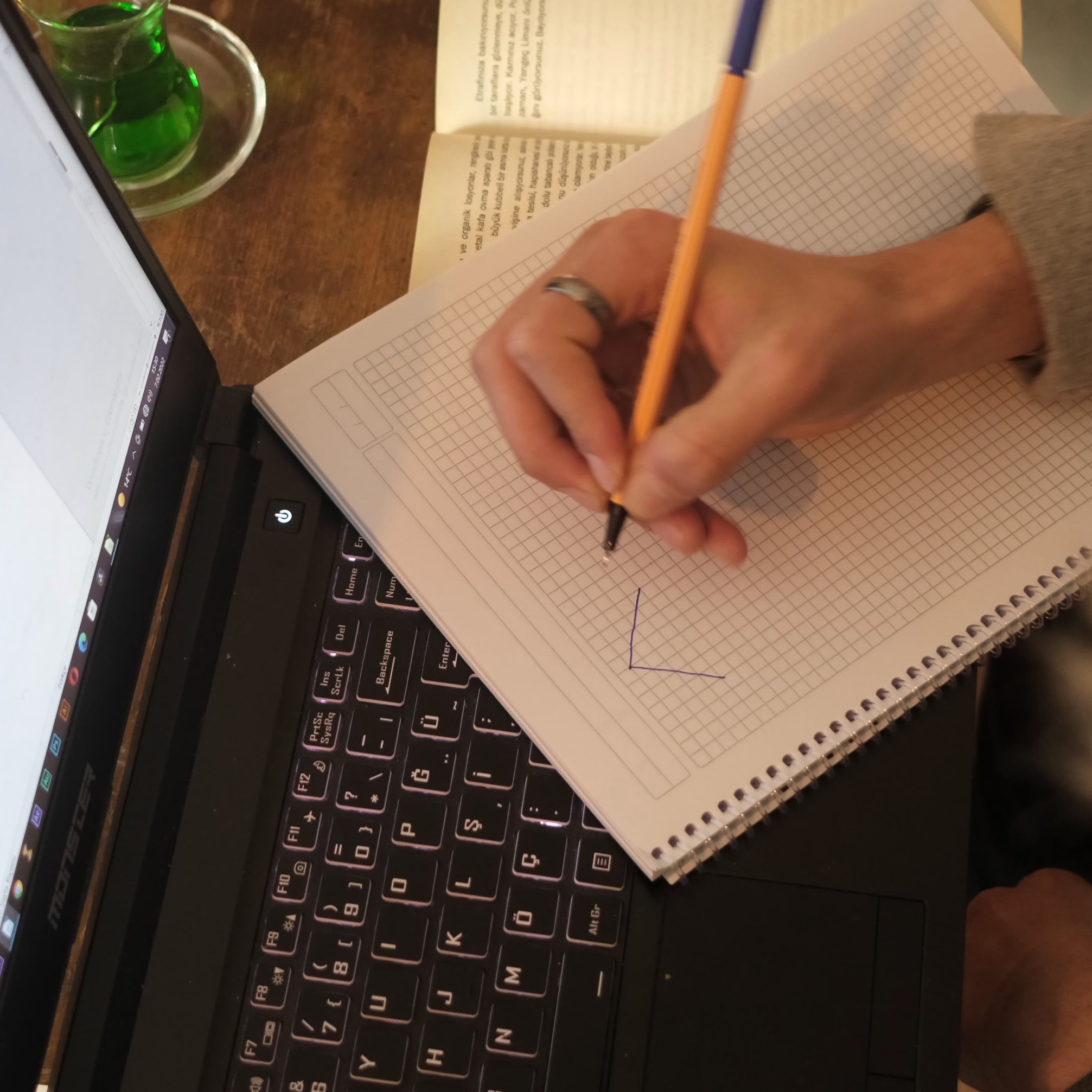 male-working-looking-at-his-notes-on-the-computer-screen