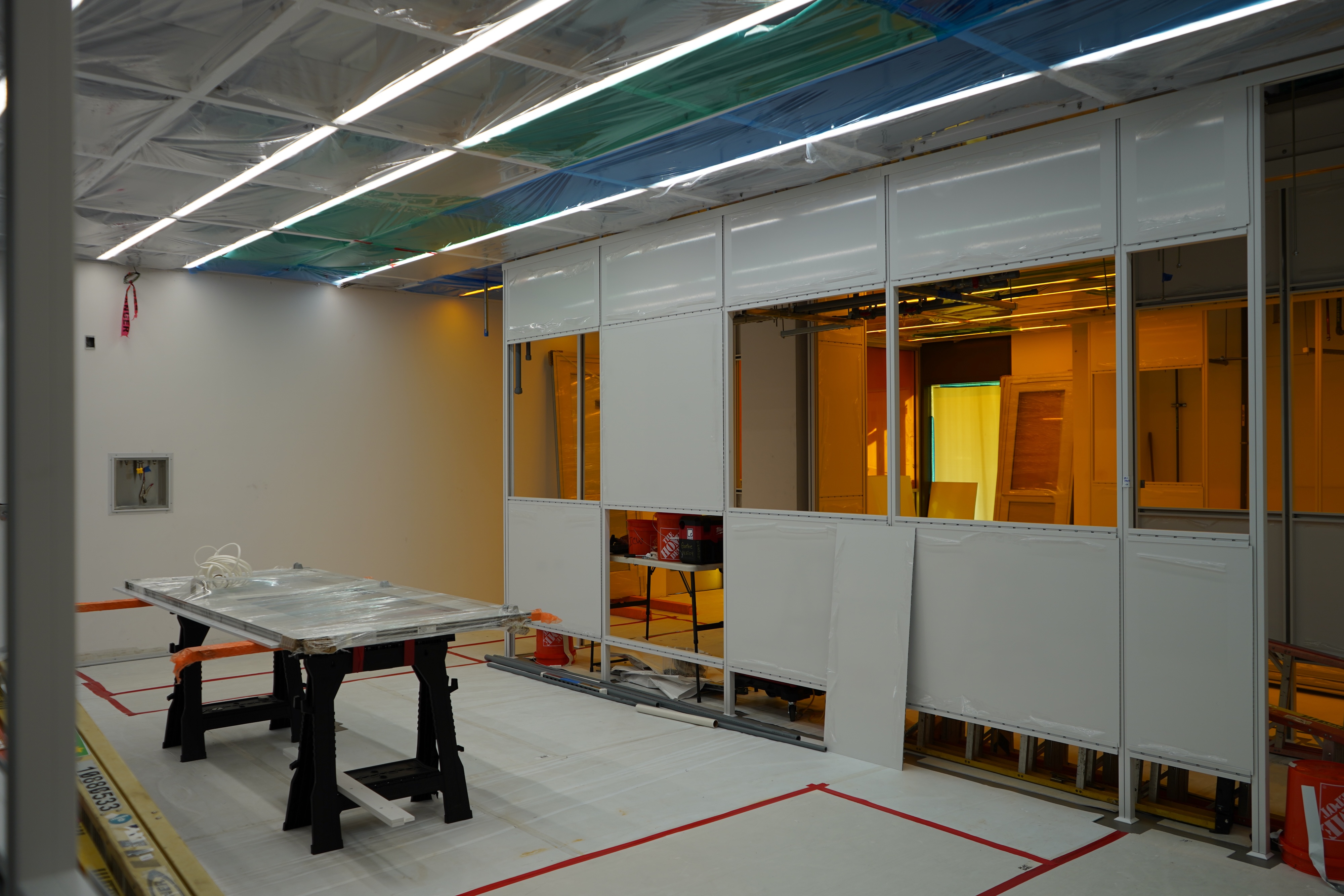 Cleanroom with workstation and orange-tinted windows.