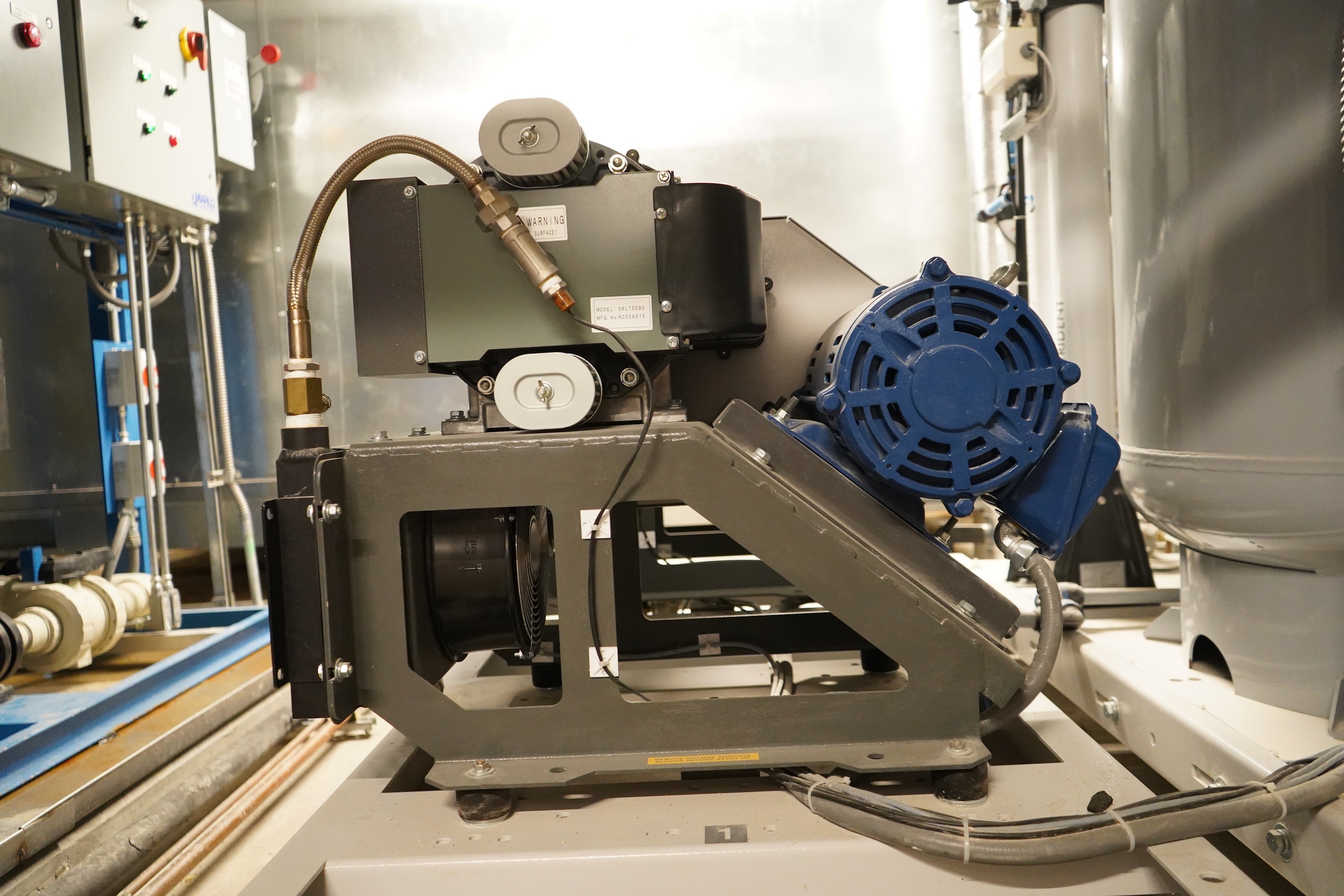 Industrial pump with blue motor and grey frame.