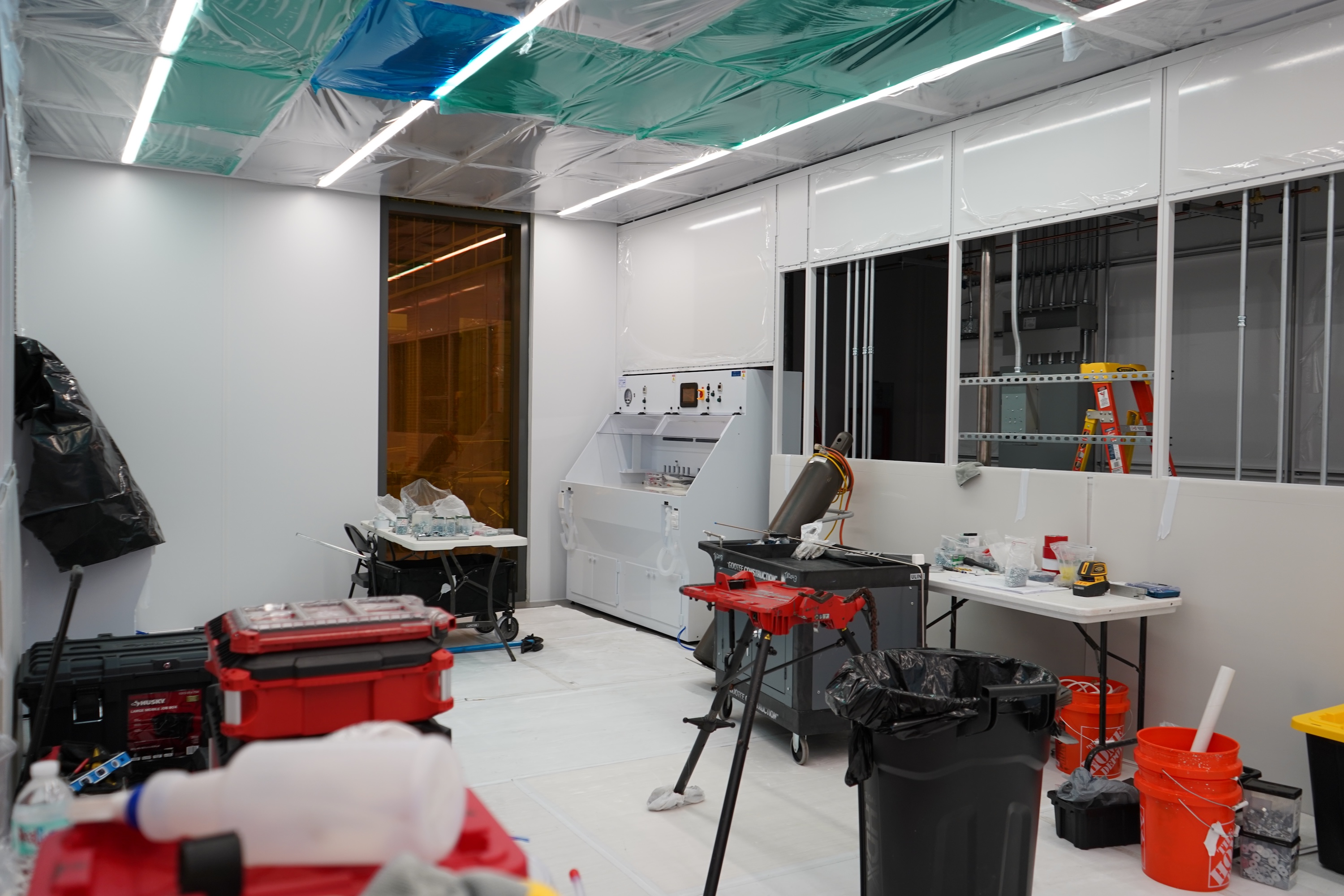 A cluttered workshop room with tools and equipment.