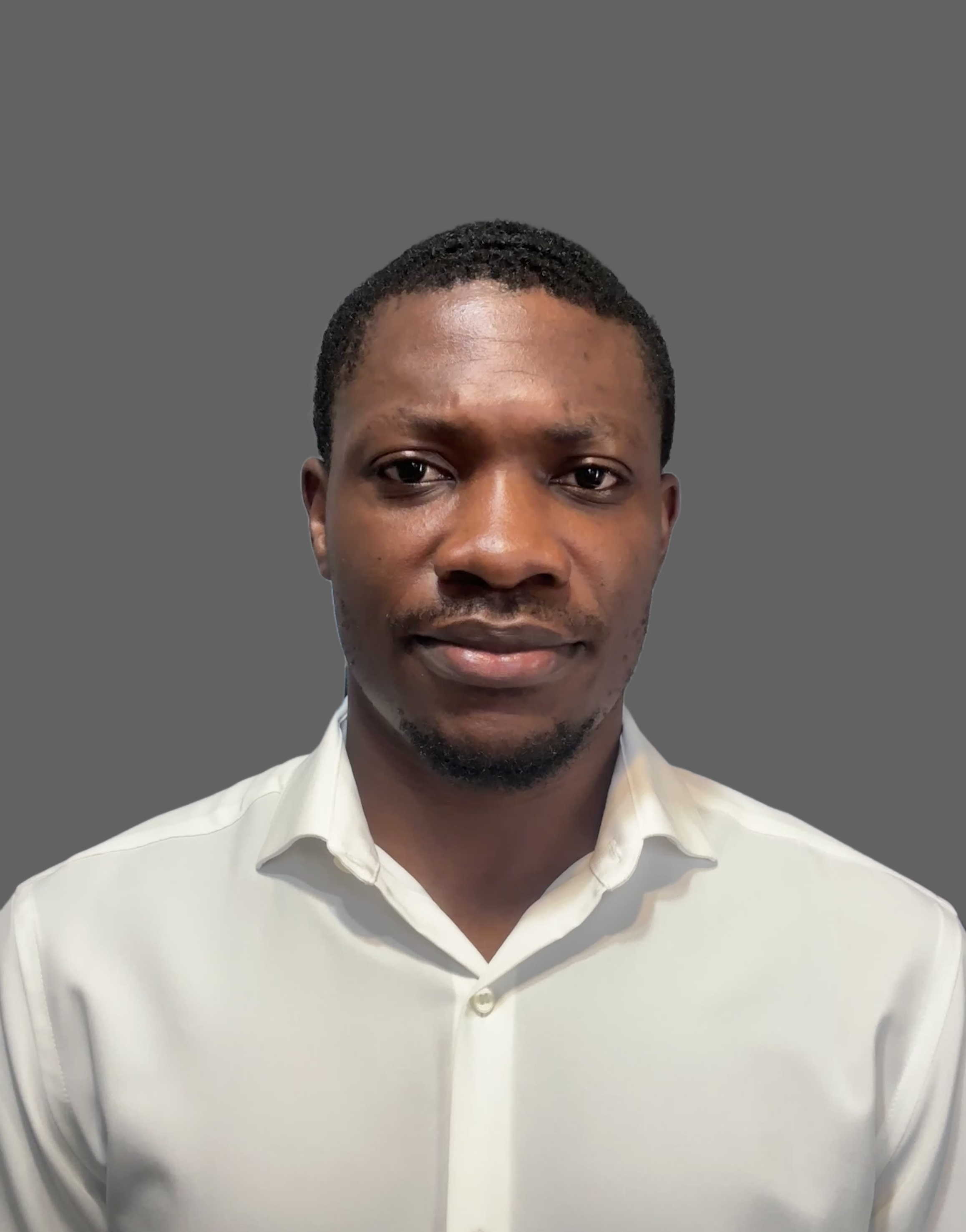 Headshot of a Black man in a white collared shirt against a gray background.
