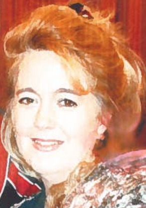 Woman with reddish-blonde hair smiling.
