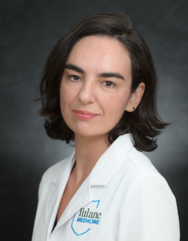 Woman in white lab coat with "Fulane Medicine" logo.