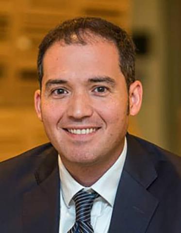 Man in suit and tie smiling at camera