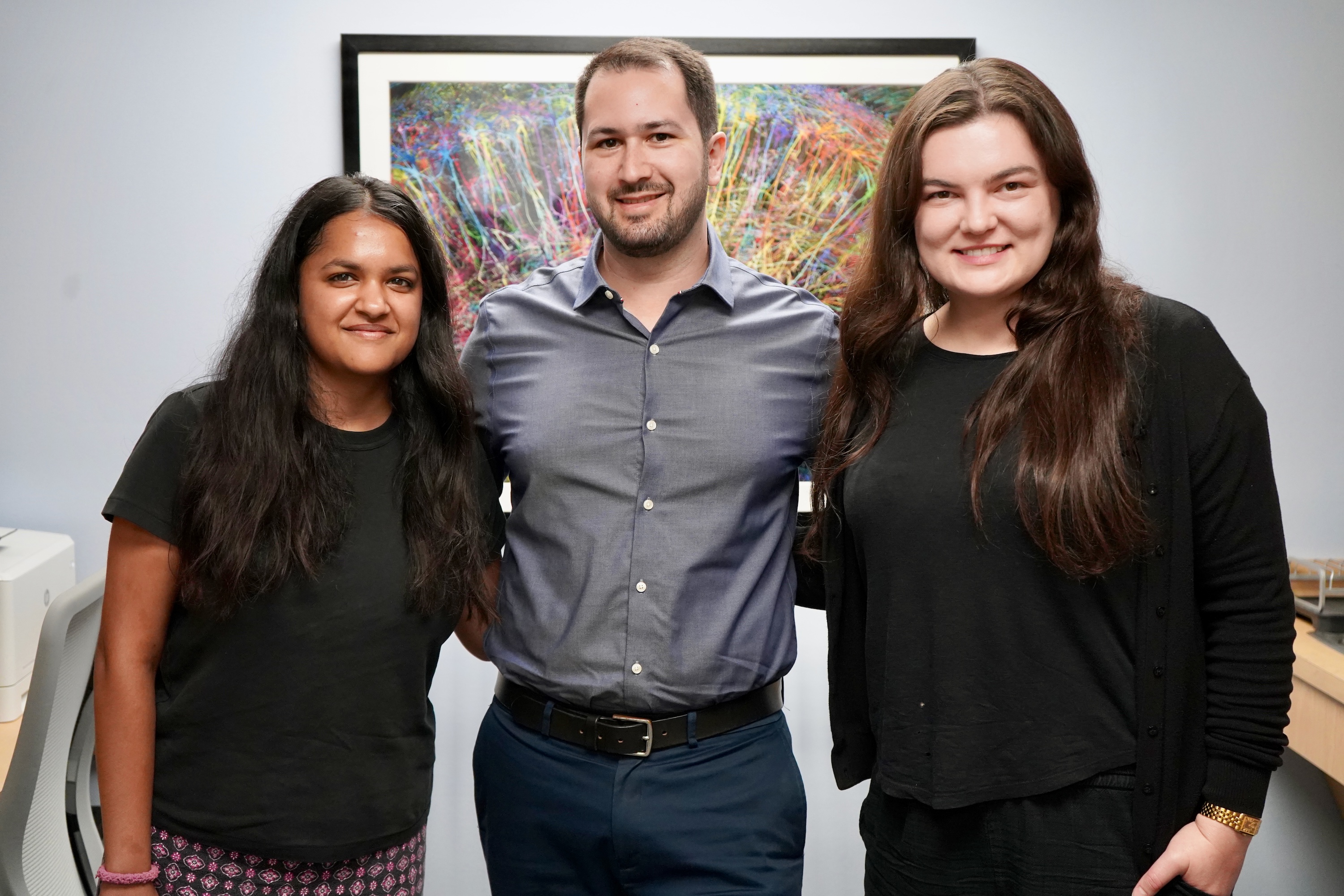 A man and two women standing together smiling