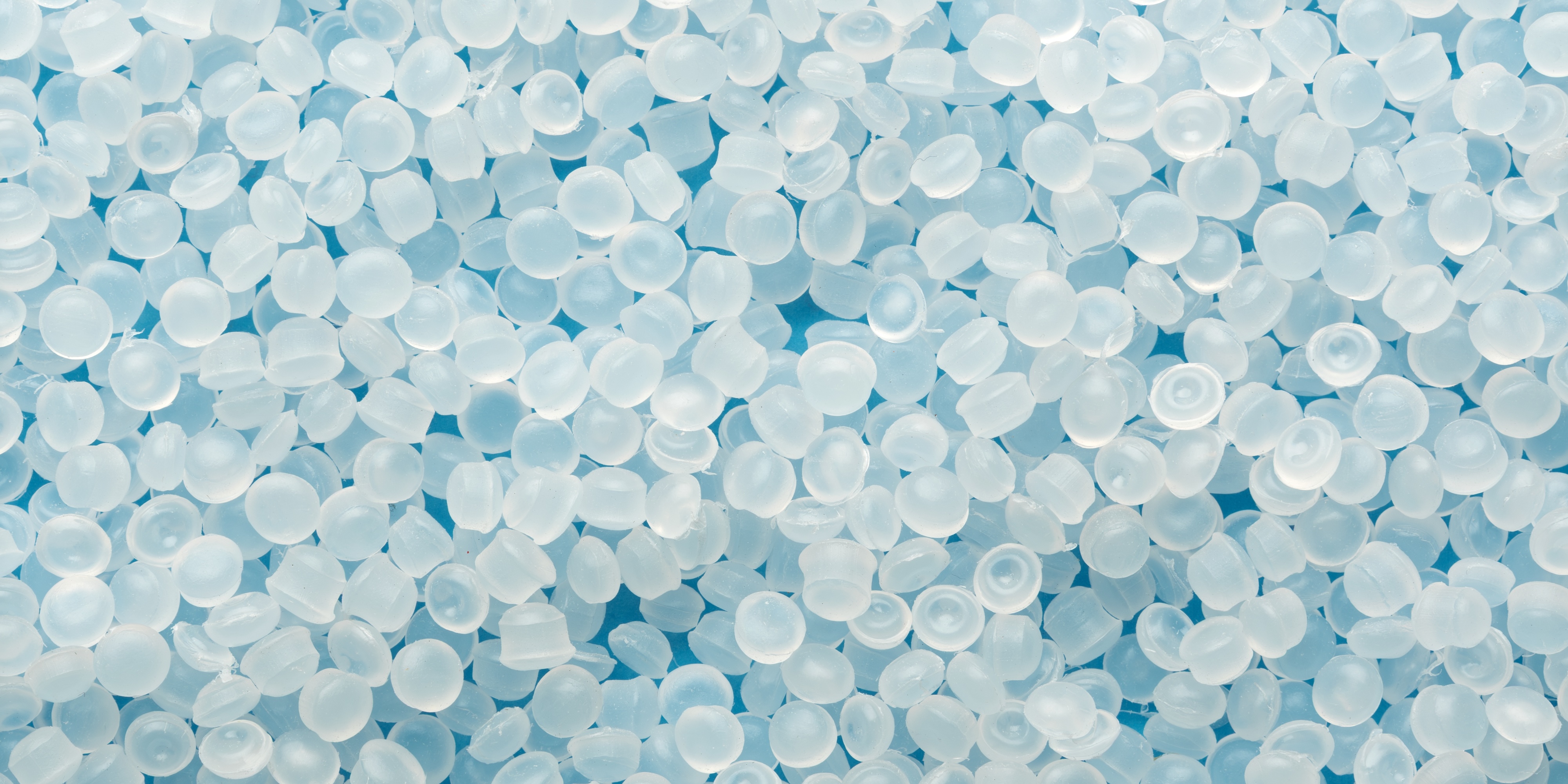 Photograph of pale blue plastic pellets.
