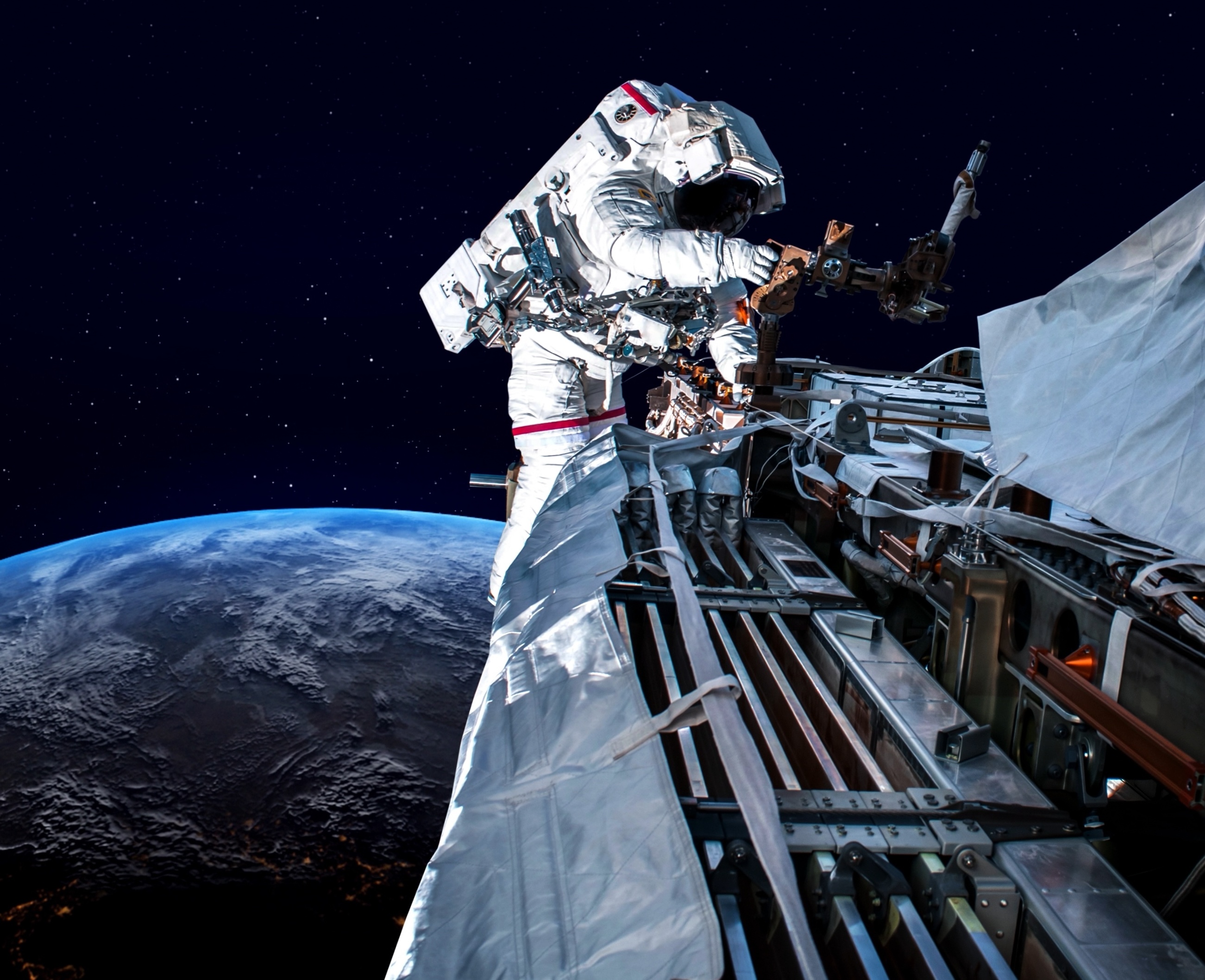 Astronaut performing spacewalk on ISS with Earth below.