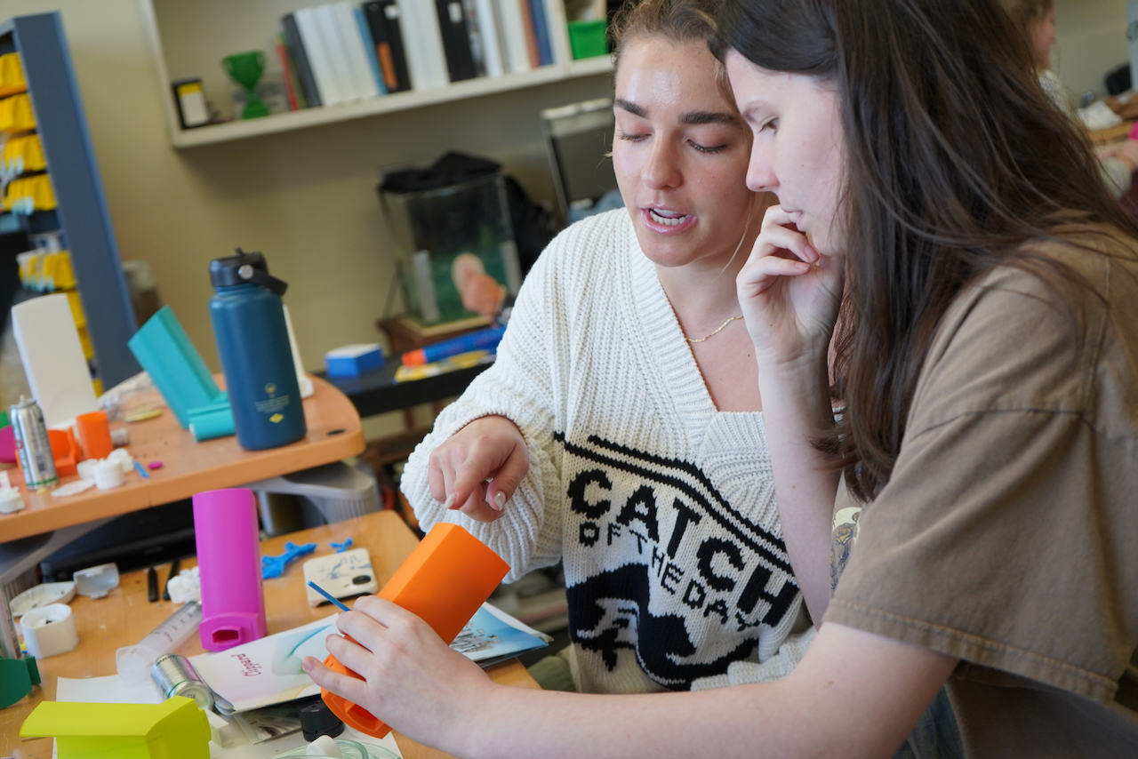 student pointing at a medical device for inhalers