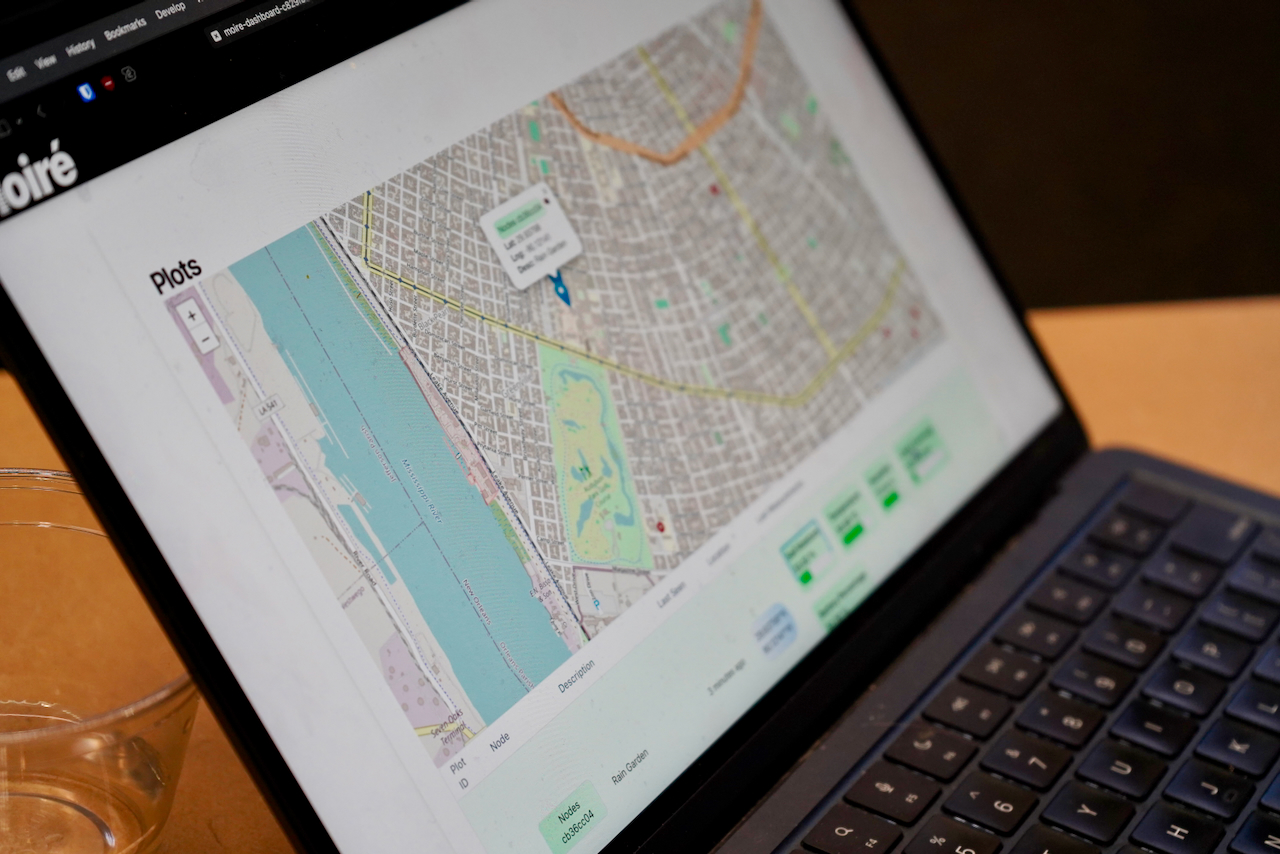 Laptop displaying a map with a blue marker and information bubble.