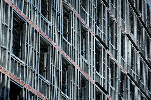 Metal framing and open windows on a building under construction.