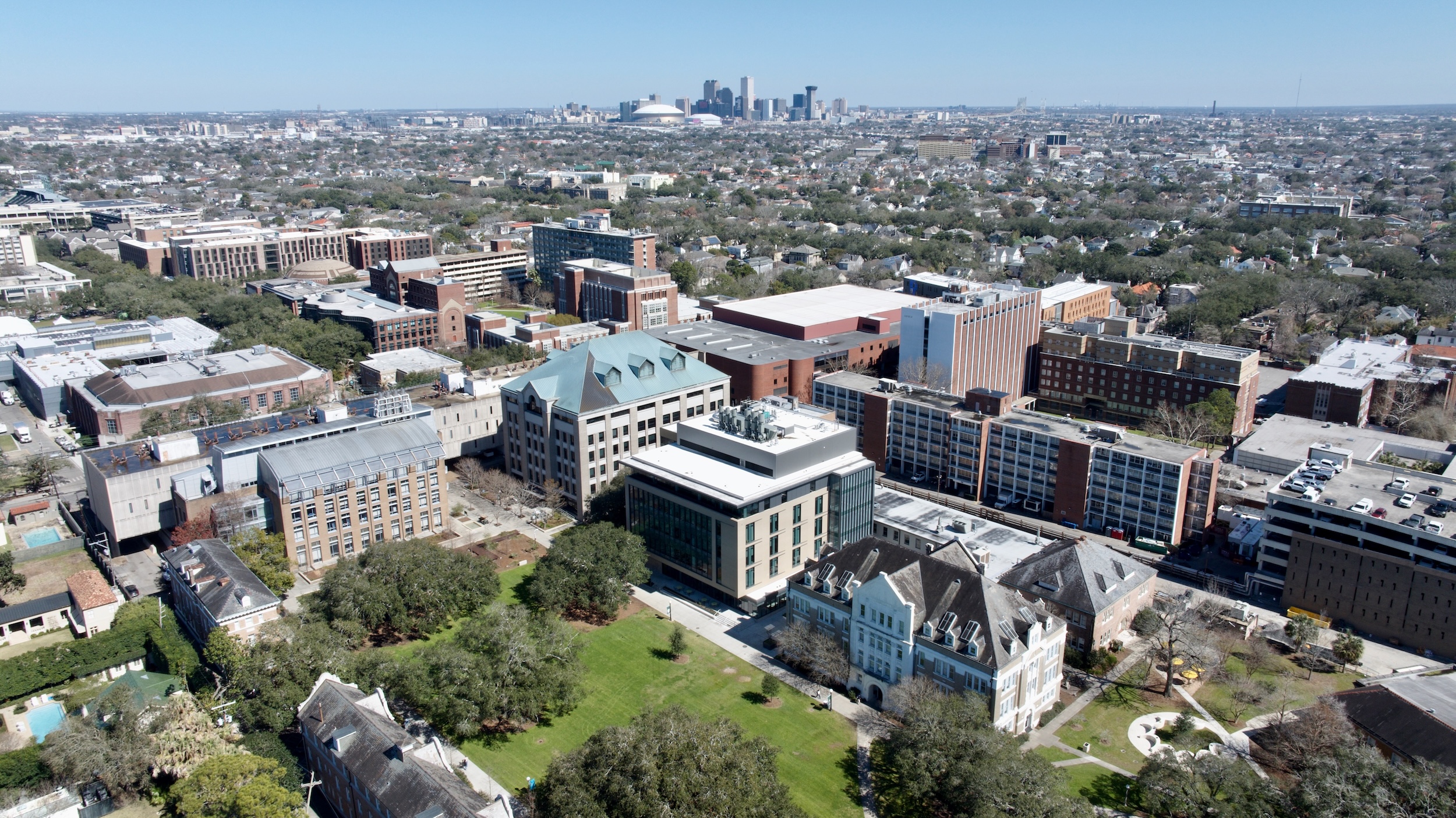 Aerial photograph of a university campus with buildings and green spaces.