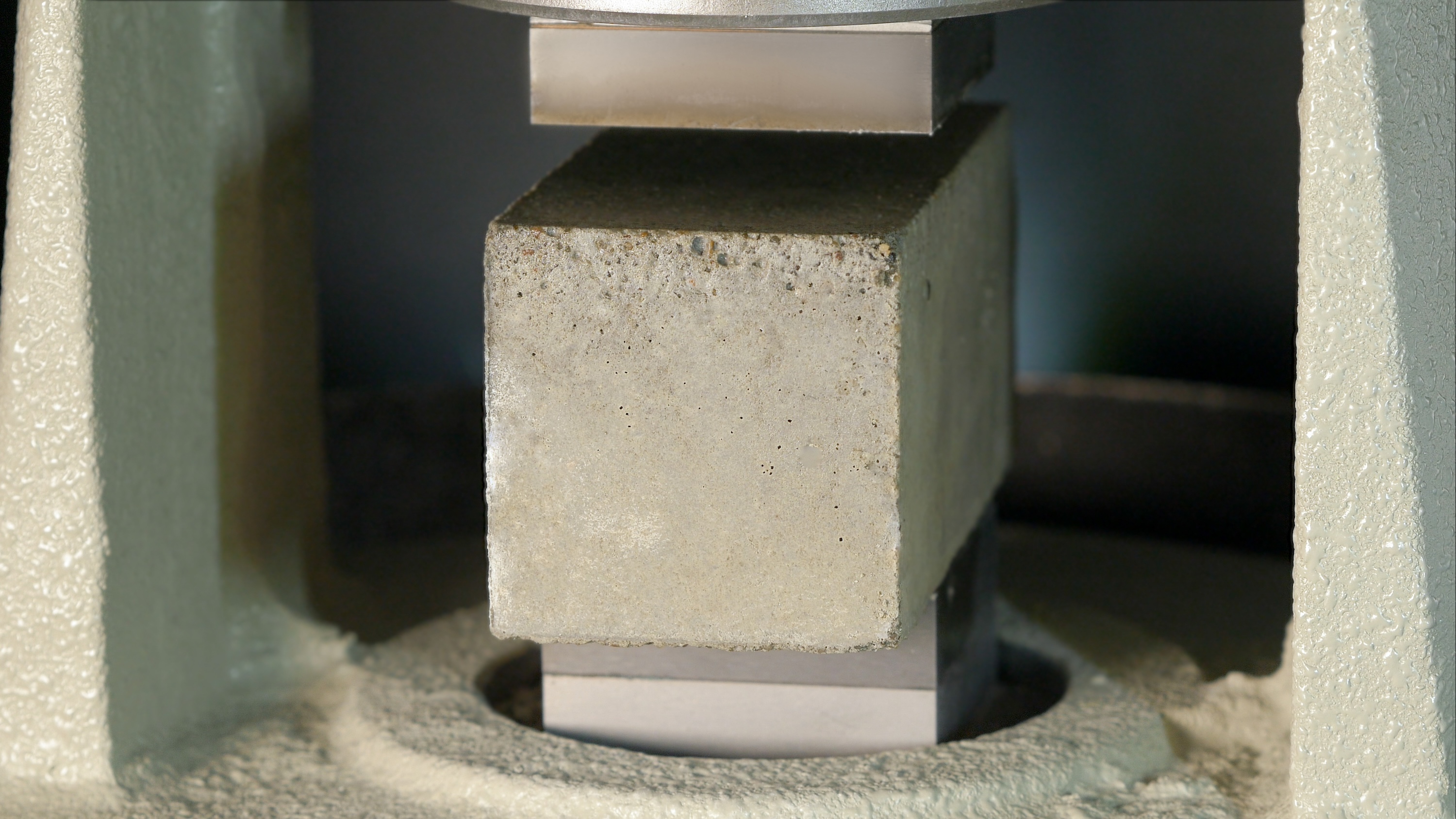 Block of cement in a hydraulic press