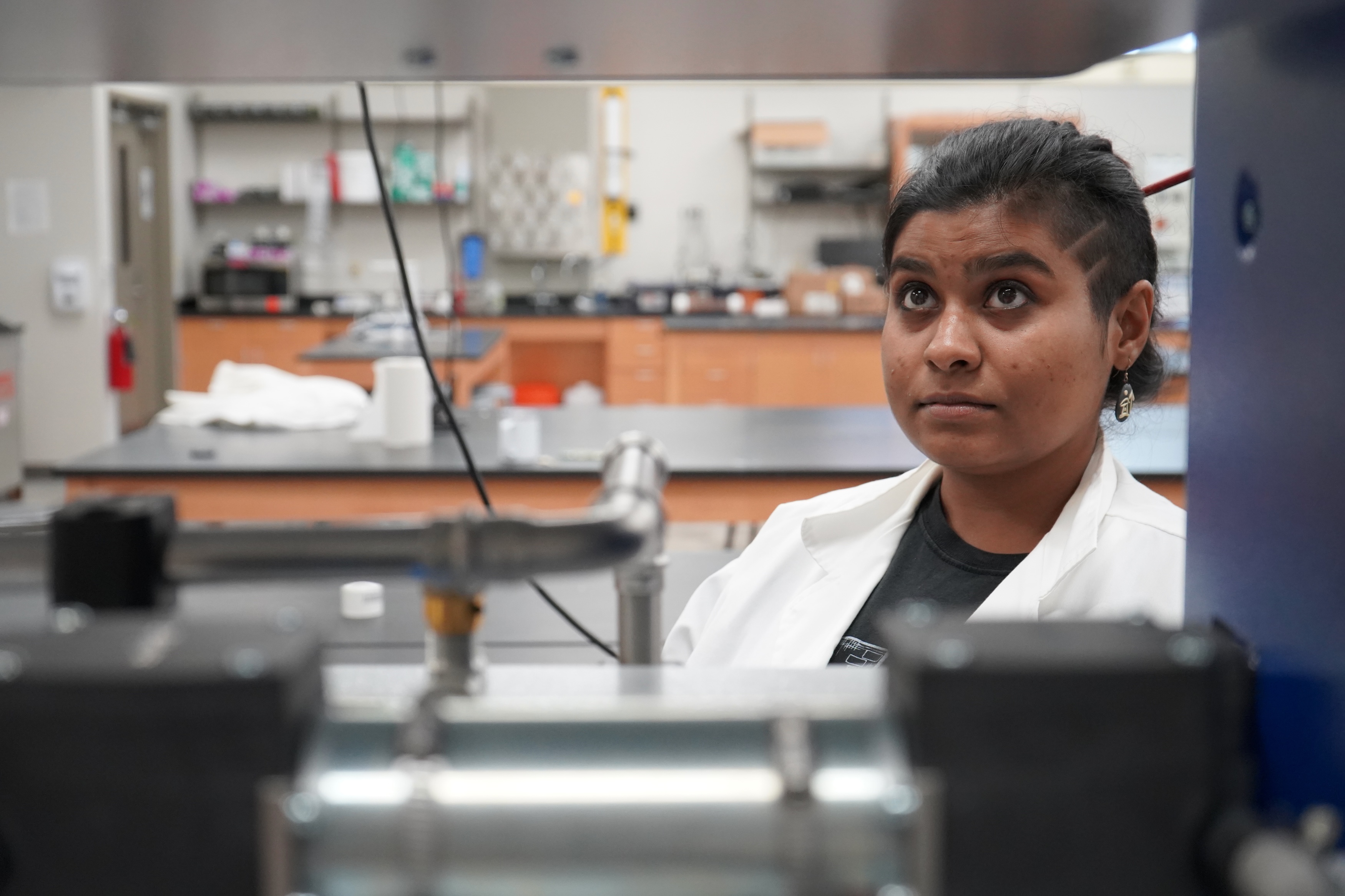 Photograph of a focused researcher in a laboratory.