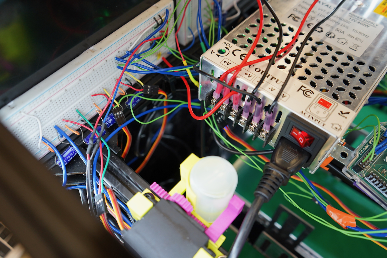 Close-up photograph of a power supply unit with tangled colorful wires.