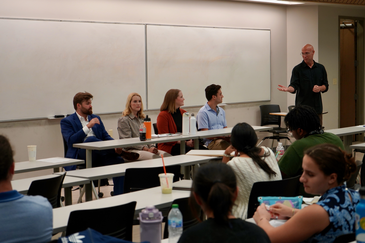 Photograph of a panel discussion in a lecture hall with an audience.