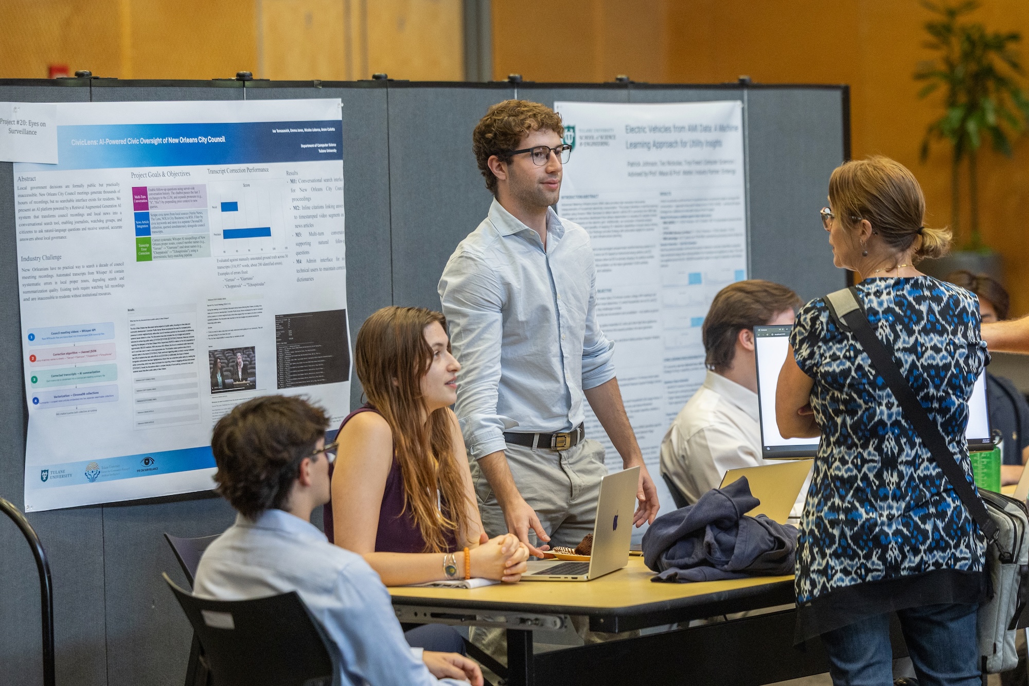 Photograph of students presenting research posters at an academic conference.