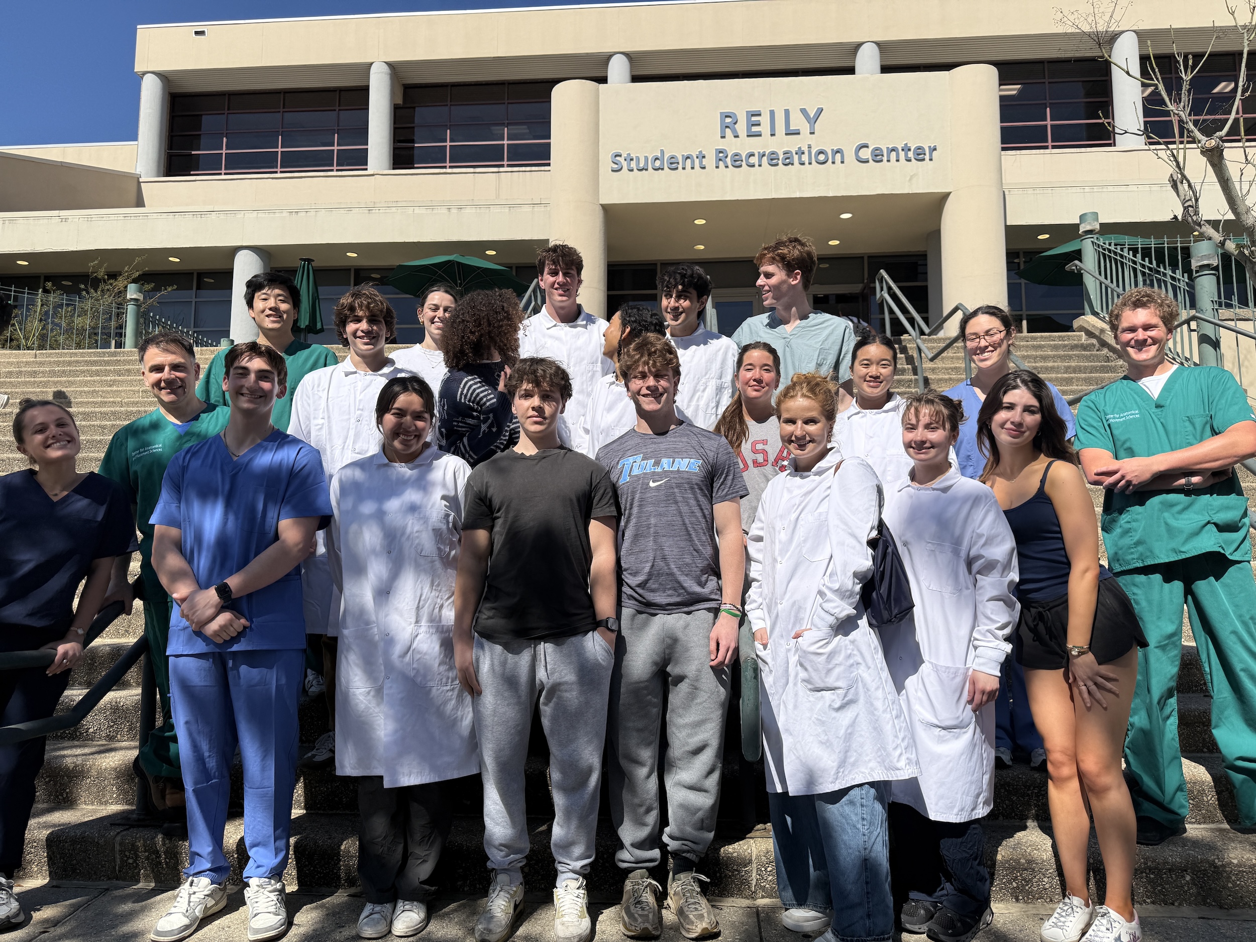 Photo of a large group of students standing in front of the Reily Student Recreation Center.