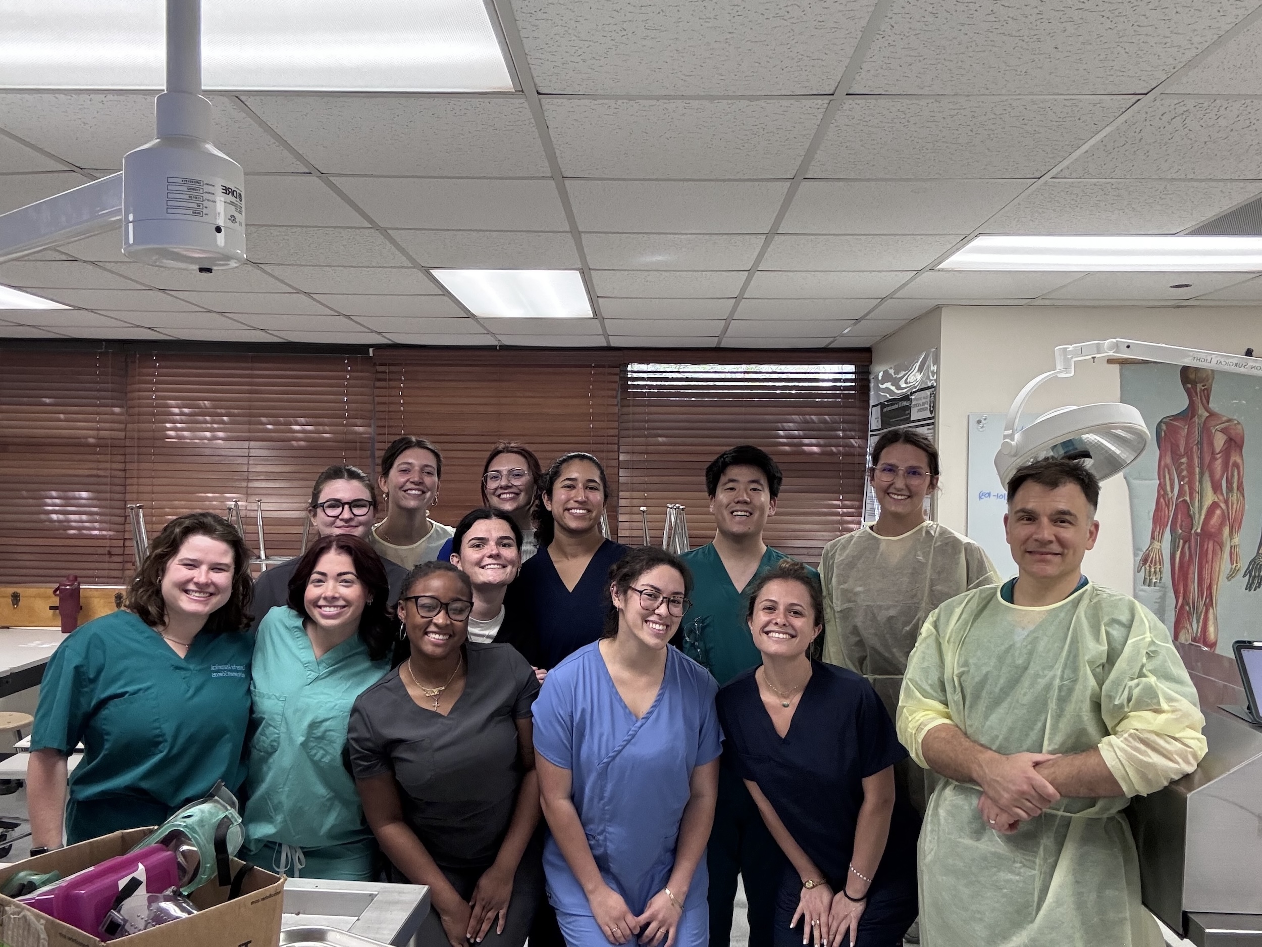 Photo of a diverse group of medical students smiling in a lab.