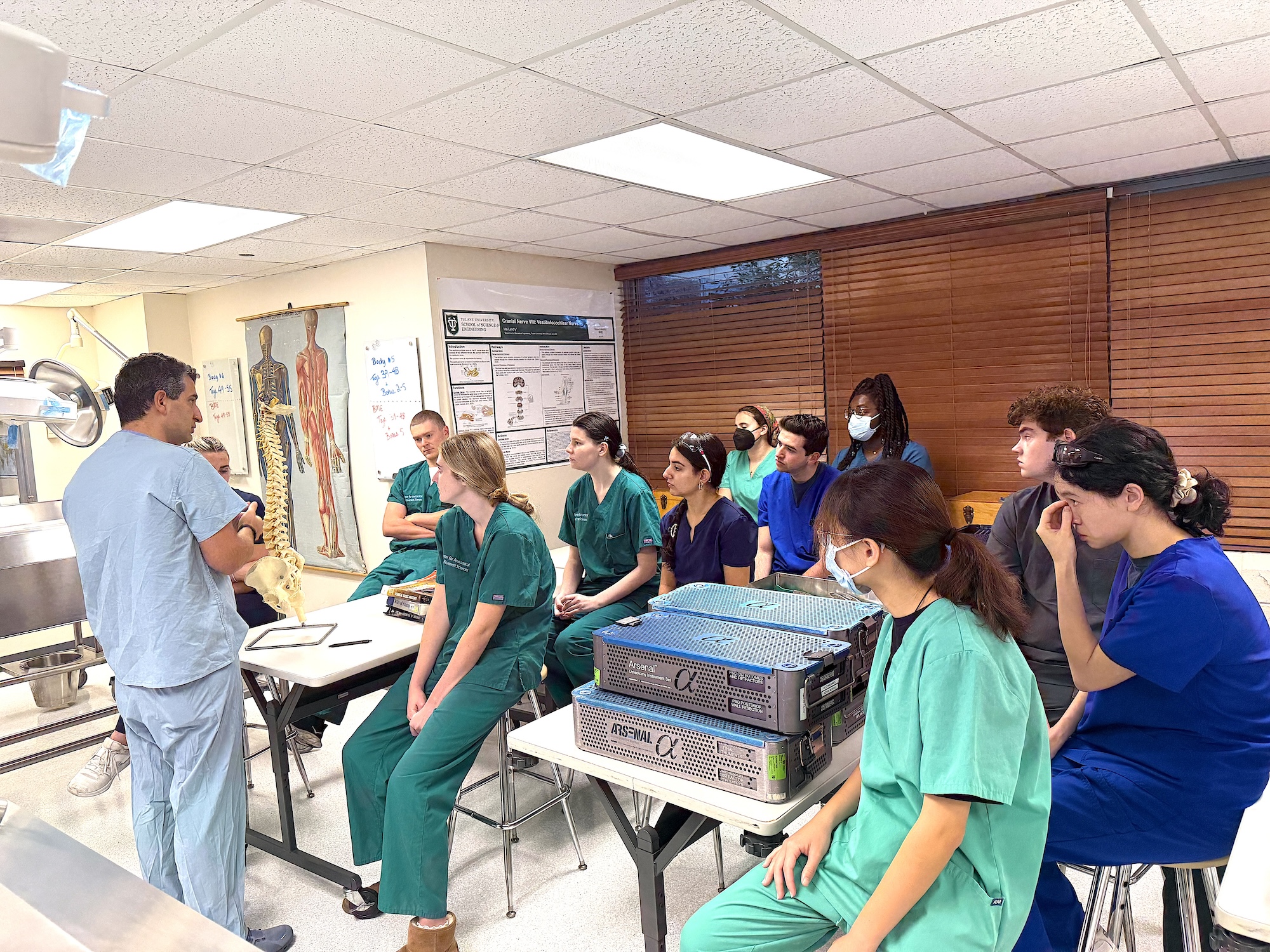 Photograph of a medical instructor teaching students in a classroom.