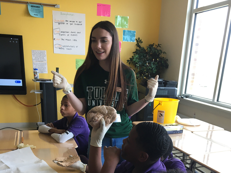 Undergraduate service learning student teaching students about the brain