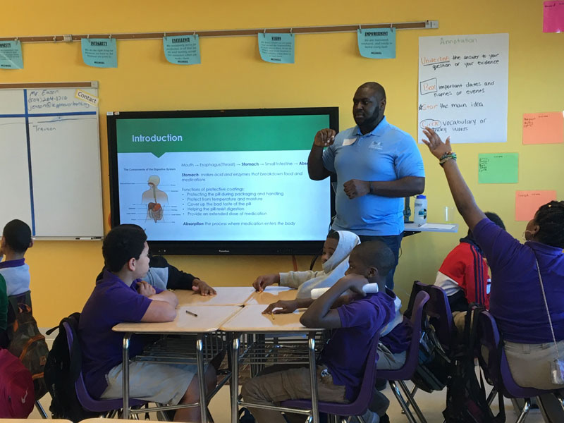 Graduate student leader teaching middle school students