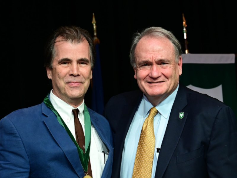 Jeffrey Tasker Receiving Awards from President Michael A. Fitts