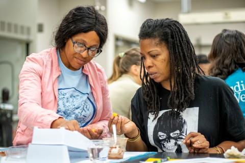 Teachers work together to conduct science experiment at Girls in STEM at Tulane.