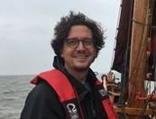 Man wearing a life vest on a boat.