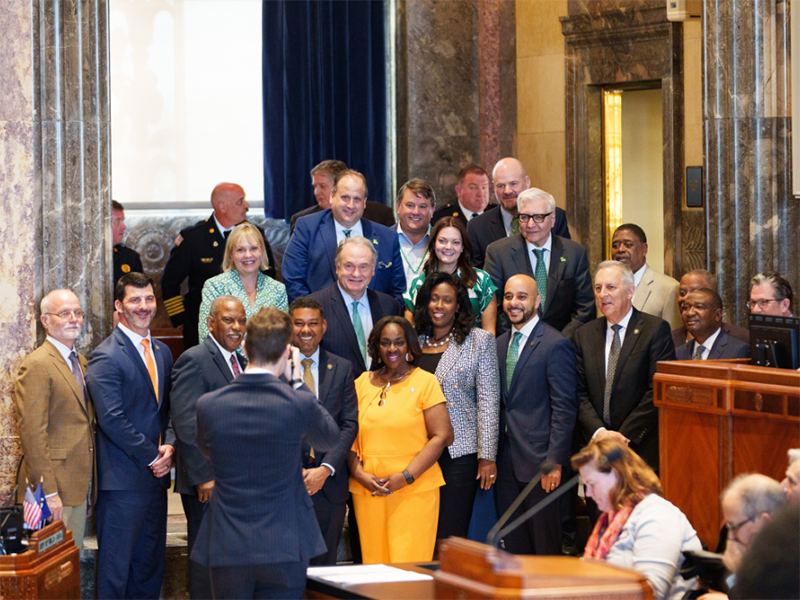 President Michael A. Fitts stands with Louisiana State Senate members and university leaders on the Senate floor following the reading of the proclamation recognizing Fitts' 10 years as president.