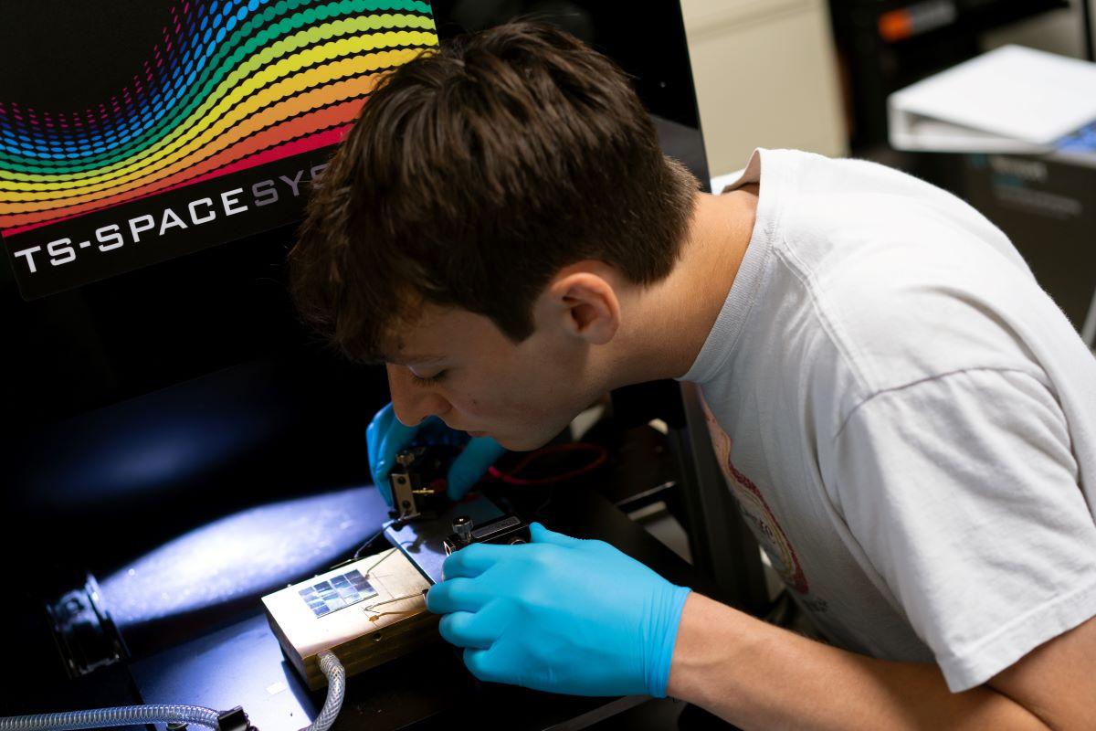 A student working on a solar materials project as part of his undergraduate research experience.