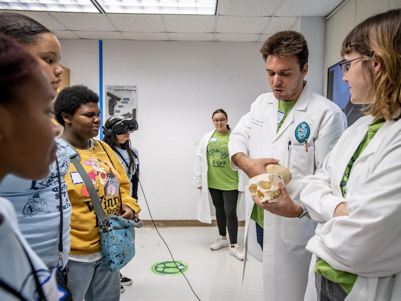 BME graduate students Rachel Tabor & Ashley Martier and Prof. Dylan A. Lucia teach local K–12 students about anatomy.