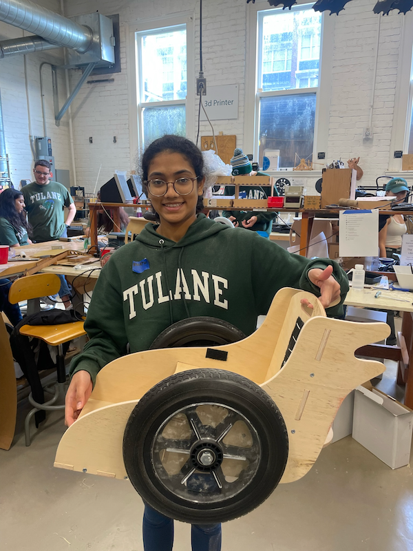 Swathi Katakam (Tulane BME) holds an in-progress rolling chair.